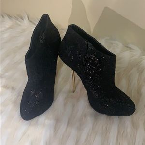 Black booties with gold heel.